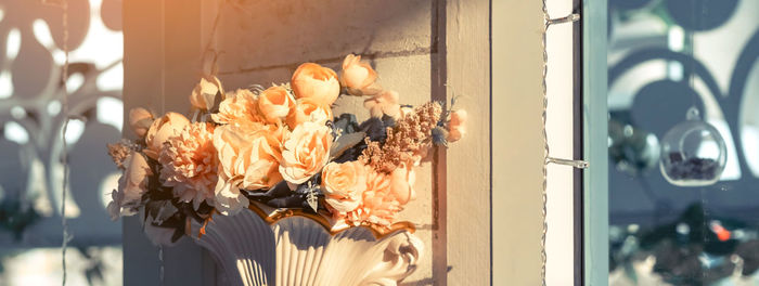 Close-up of flowers on window at home