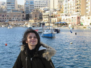 Portrait of smiling young woman in city