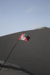 Low angle view of flag against clear sky