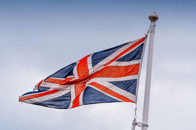 Low angle view of british flag against sky