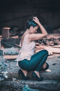 Full length of woman crouching outdoors