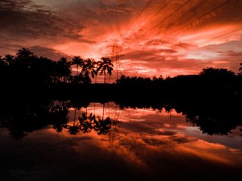 Scenic view of lake against orange sky