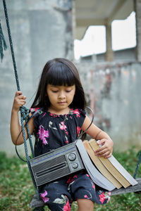 Full length of cute girl holding camera