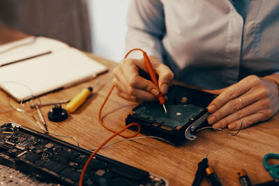 Midsection of businessman working at desk in office