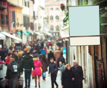 Crowd on street amidst buildings