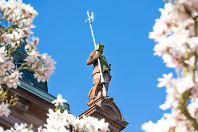 Low angle view of statue against blue sky