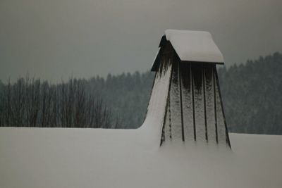 High angle view of birdhouse against trees during winter