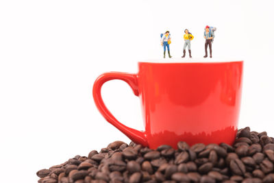 Close-up of coffee cup on table against white background