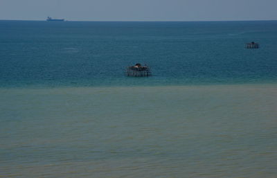 Man in sea against sky