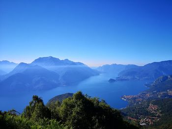 Scenic view of mountains against clear blue sky