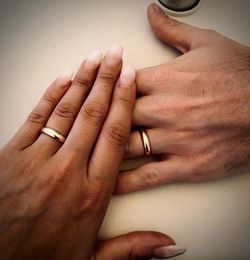 Midsection of couple holding hands