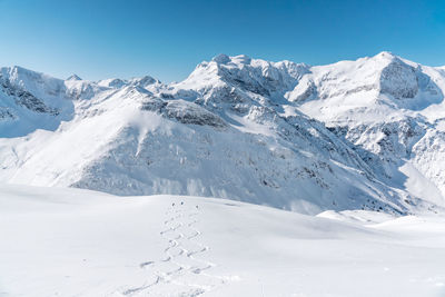 Scenic view of snow covered mountains against sky