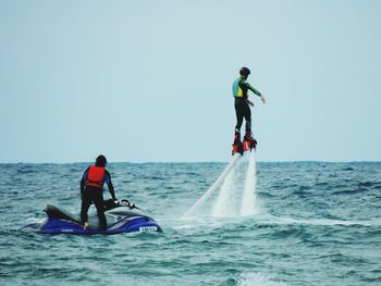 People surfing in sea