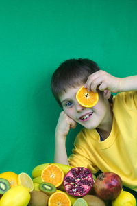 Portrait of boy holding fruits