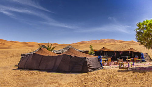 Tent on desert against sky
