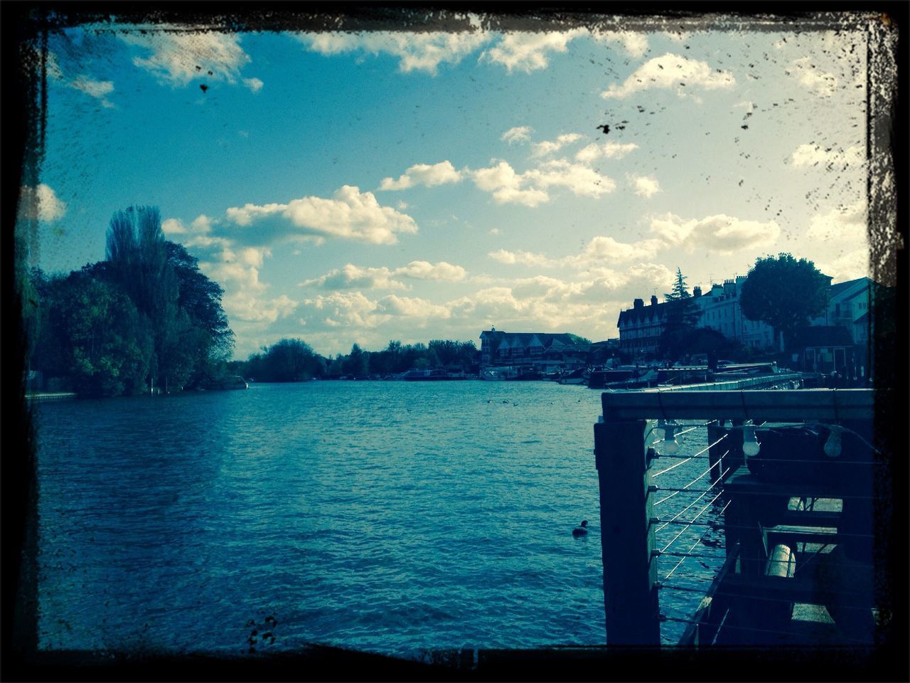 transfer print, water, auto post production filter, sky, blue, cloud, cloud - sky, river, building exterior, lake, tree, waterfront, reflection, built structure, nature, architecture, scenics, silhouette, tranquility, outdoors