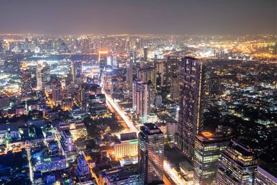 High angle view of illuminated buildings in city at night