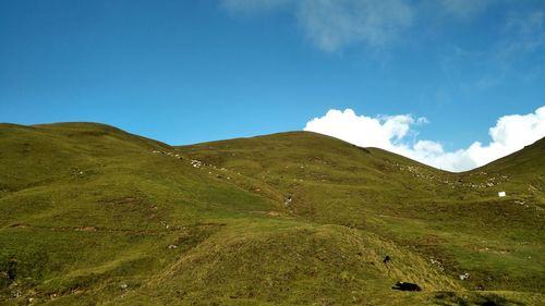 Scenic view of mountains against blue sky