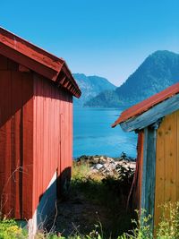 Hut by house against sky