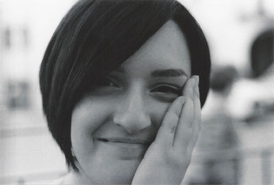 Close-up portrait of smiling young woman