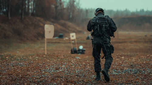 Rear view of man standing on field