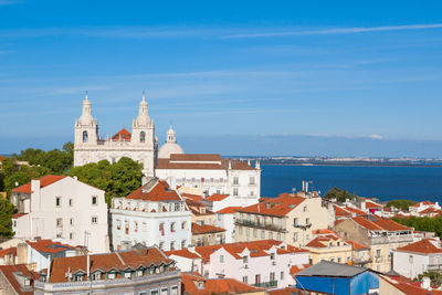 Buildings in city against blue sky