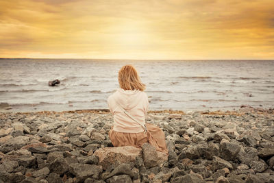 Rear view of man looking at sea shore