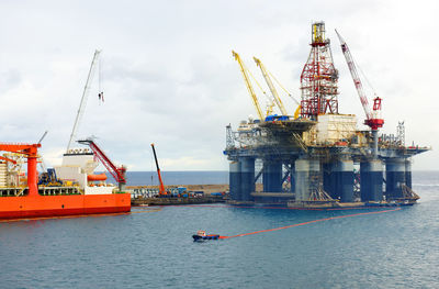 Offshore platform amidst sea against sky