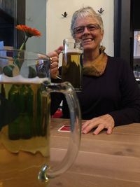 Smiling man with drink on table