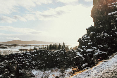 Scenic view of frozen mountains against sky