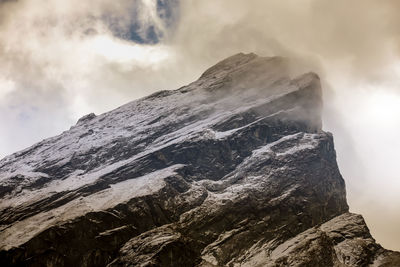 Low angle view of snowcapped mountains against sky