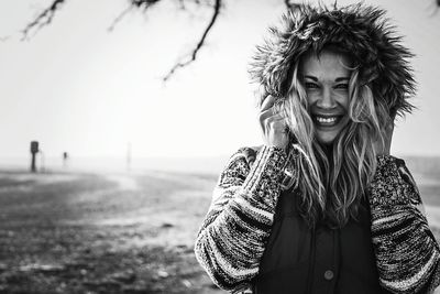 Portrait of smiling woman wearing hood during winter