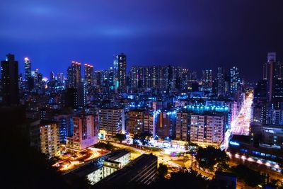 Illuminated cityscape against sky at night