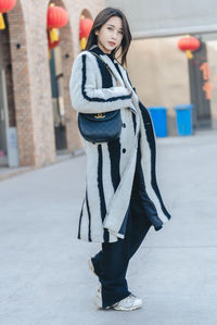 Low section of woman standing on street