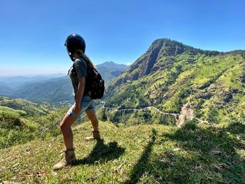 Full length of man standing on mountain against sky