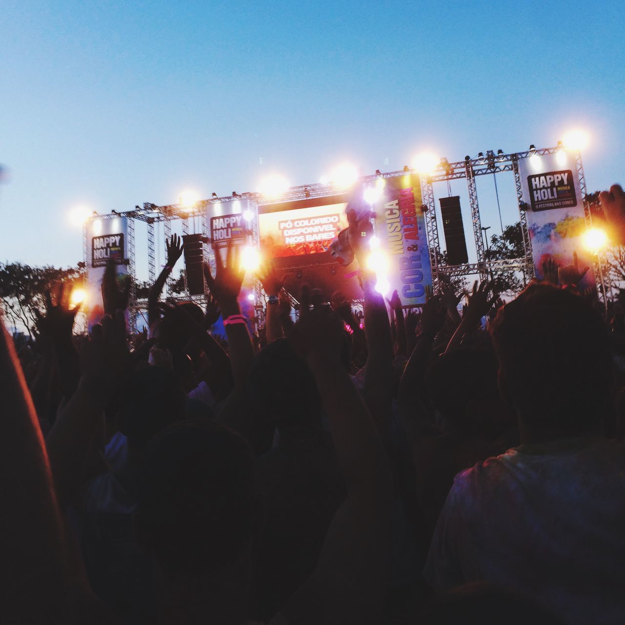 illuminated, large group of people, night, lifestyles, leisure activity, crowd, men, enjoyment, person, celebration, lighting equipment, fun, arts culture and entertainment, togetherness, event, lens flare, light - natural phenomenon, light beam, building exterior