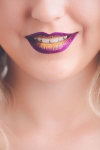 Cropped image of woman with purple lipstick