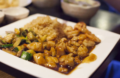 Close up of a teriyaki chicken, shrimp and vegetable meal, with the focus on the chicken