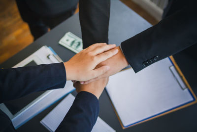 Midsection of couple holding hands