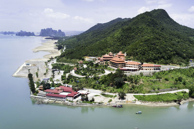 High angle view of houses by sea against sky