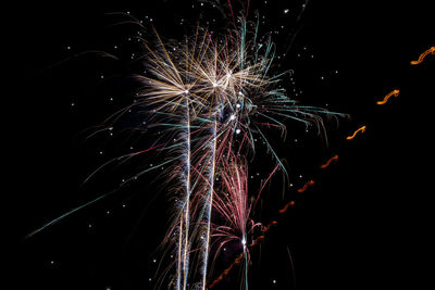 Low angle view of firework display at night