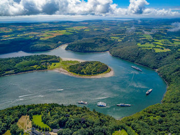 High angle view of sailboats on sea shore against sky