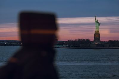 Statue of liberty against sky during sunset