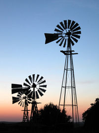 Low angle view of silhouette windmill against sky during sunset