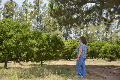 Rear view of woman standing on field