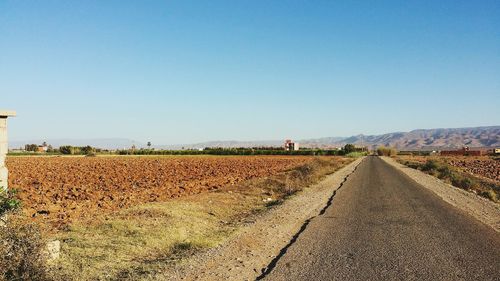 Scenic view of agricultural field against clear sky