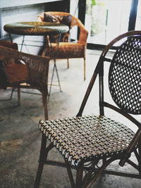 Empty chairs and table at sidewalk cafe