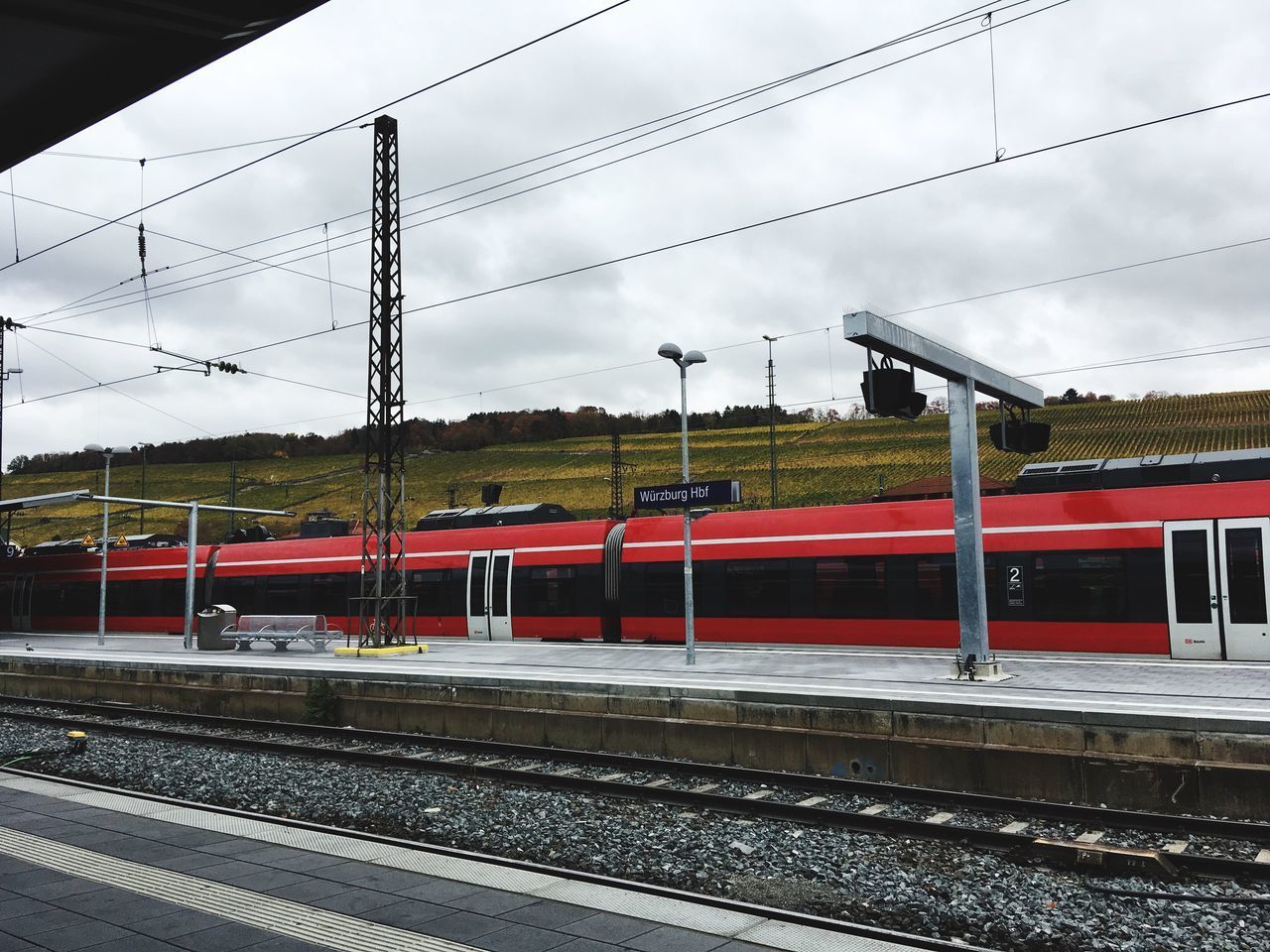 TRAIN ON RAILROAD STATION PLATFORM