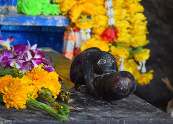 Religious offerings by statue at shrine