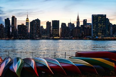 Scenic view of river and buildings against sky